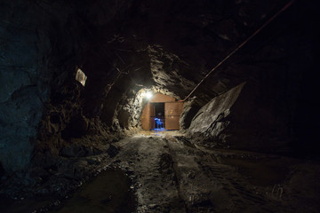 Underground gold quartz mine tunnel with doors