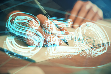 Multi exposure of woman's hands making notes with SEO icon. Concept of Search engine optimization