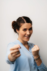 Young happy girl showing fists and ready to fight