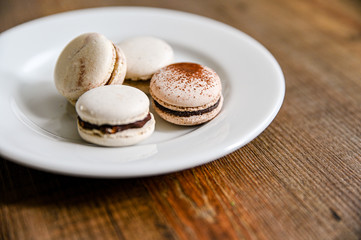 Several pieces of delicious French cookie - macrons. Chocolate flavor.