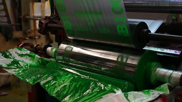 The Gravure plastic bag printer is working, see the rotating steel blocks in the color tray.