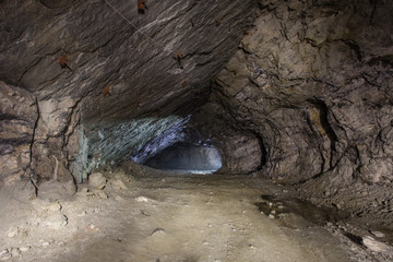 Underground gold quartz mine tunnel with light