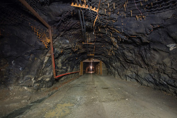 Underground gold quartz mine tunnel with light