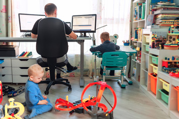 Father with kids working from home during quarantine. Stay at home, work from home concept during...