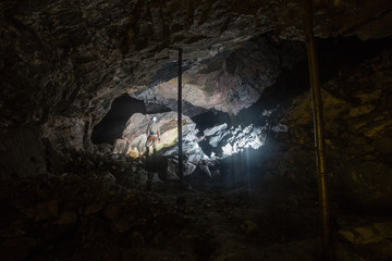 Miner in underground gold quartz mine tunnel