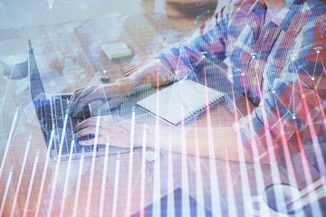 Multi exposure of forex graph with man working on computer on background. Concept of market analysis.