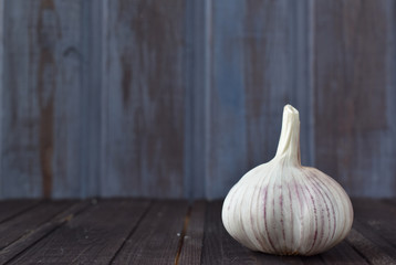 Garlic. Garlic and garlic bulbs on a purple background wooden table.