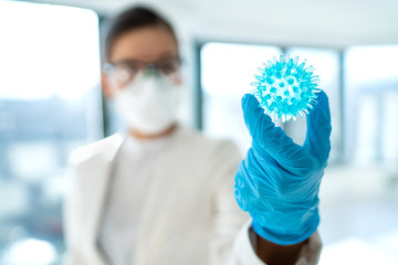 Coronavirus lab research woman researcher finding vaccine cure holding corona virus blue model of...