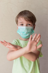Portrait of Toddler kid wearing medical mask.A boy wearing mouth mask against pandemic. Concept of coronavirus quarantine or covid-19.  Easter stay home concept
