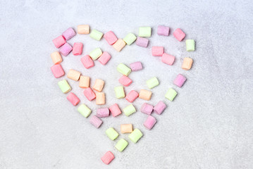 Heart Marshmallow on Gray Background Background with Colorful Miniature Marshmallows Horizontal