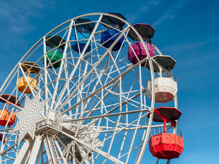 Amusement park, colorful ferris wheel.  Side view.