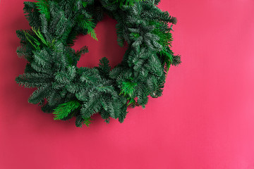 Fototapeta na wymiar Blank for Christmas wreath on a pink background. Christmas wreath of spruce and cypress. Fir and cypress branches. Side view