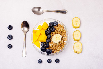 Bowls of Muesl and Yogurt with Berry and Mango Healthy Breakfast Diet Food Flat Lay