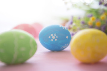 Obraz na płótnie Canvas Easter eggs on a pink wooden surface