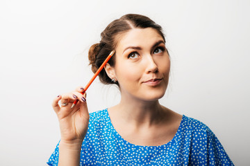 Girl thinking with a pencil