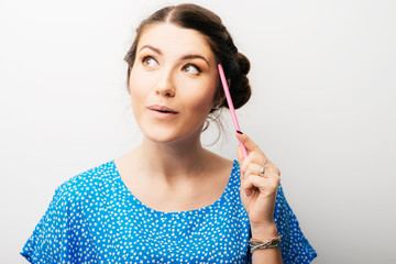 Girl thinking with a pencil