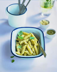 paghetti with pesto and olive oil on a white background