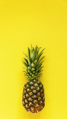 Front view of pineapple on yellow background  homemade juice