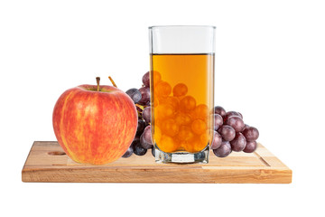 ripe apple, a glass of apple juice and a brush of black grapes on a  kitchen board isolated on a white background