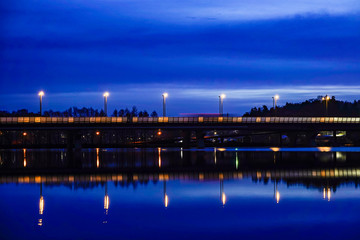 Fototapeta premium Stockholm, Sweden Night landscape over Lake Mälaren looking towards Varby and the E4 highway.