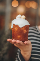Little Easter cake photographed in hands, celebration of the light holiday of the Resurrection of the Lord