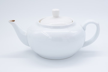 cup with tea and teapot on white  background, over light