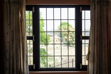 Fototapeta na wymiar Indoors Looking out a Window with Bars