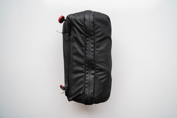 Black suitcase full and close with a zipper