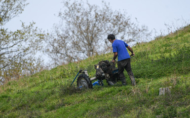 farmer mowing the grass