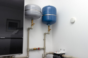 Group of expansion tanks in house boiler room