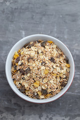 dry muesli in the bowl on ceramic background