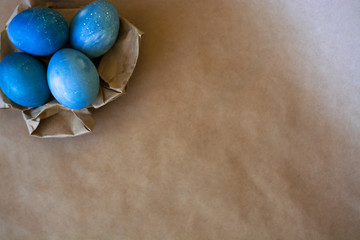 Easter holiday decorations, background. Basket with painted blue eggs, with bars, branches, flowers. Religion.