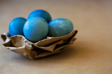 Easter holiday decorations, background. Basket with painted blue eggs, with bars, branches, flowers. Religion.