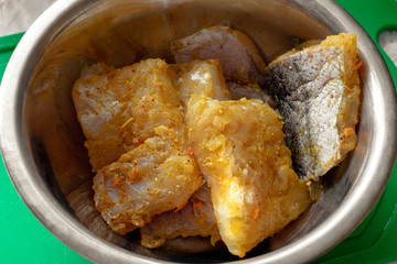 Raw fish with spices. Sliced raw fish in a bowl