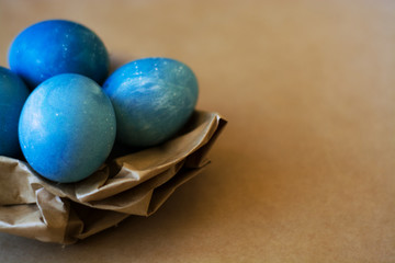 Easter holiday decorations, background. Basket with painted blue eggs, with bars, branches, flowers. Religion.