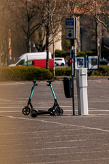 e scooters stand in car parking lot