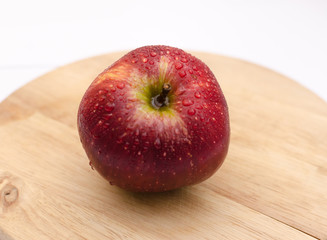 fresh red apples close-up on a light wooden background, healthy health products