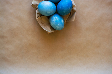 Easter holiday decorations, background. Basket with painted blue eggs, with bars, branches, flowers. Religion.