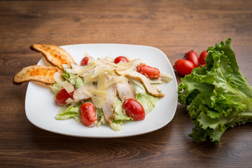 Healthy caesar salad with chicken, cheese and croutons. Top view
