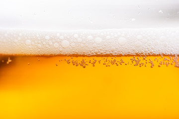 Close up of beer bubbles.