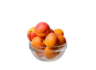 glass bowl with apricots on a white background