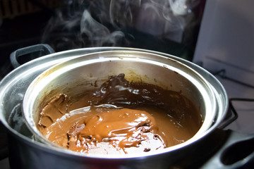 Melted chocolate in a pan under a water bath. Making hot chocolate at home in your own kitchen