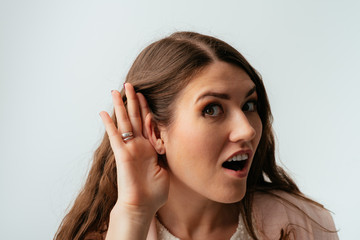 Fototapeta premium on a gray background young girl overhears
