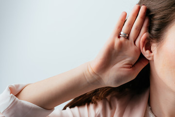 on a gray background young girl overhears