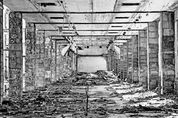 The room of a large industrial building, subjected to recycling. The prospect of piles in the form...