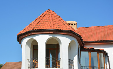 Arched shaped balcony under hexagonal roof covered with ceramic, clay tiles.