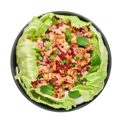 Laab Gai - Thai Minced Chicken Salad in black bowl isolated on white background. Larb is thailand cuisine dish with minced meat, fish sauce, lime juice, mint, lettuce and roasted rice. Thai Food
