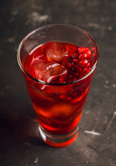 Pomegranate cocktail in highball glass. Selective focus. Shallow depth of field.