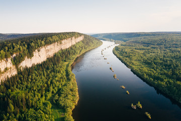 Ural nature green forest landscape with Vetlan Rock and Vishera River at sunset, panoramic aerial view. Natural scenery near Krasnovishersk, Perm Krai, Russia