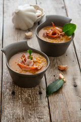 Homemade lentil soup with urad beans, red beans, butter, spices and strips of bacon. Menu or cook book concept. Lentil soup in ceramic serving bowls on light wooden table